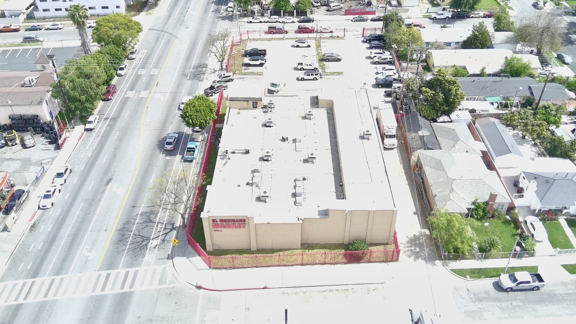 Drone view from north — building, parking, and Alondra Blvd frontage