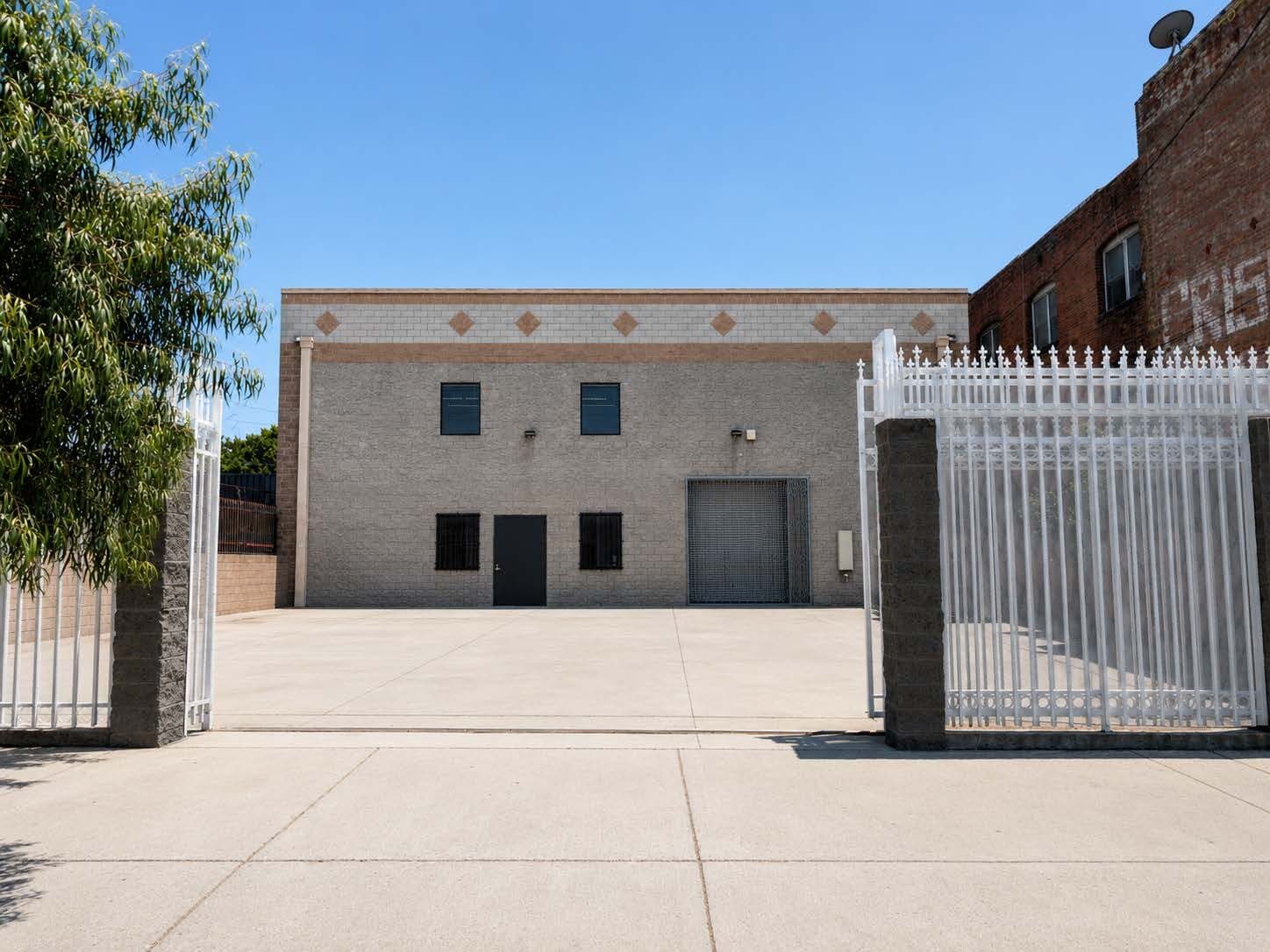 Striped on-site yard parking and secondary roll-up door at 2120 S Main St