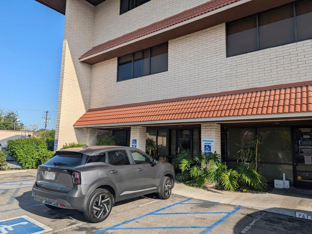 Surface parking and south elevation of 416 W Las Tunas Dr with ADA stalls at grade