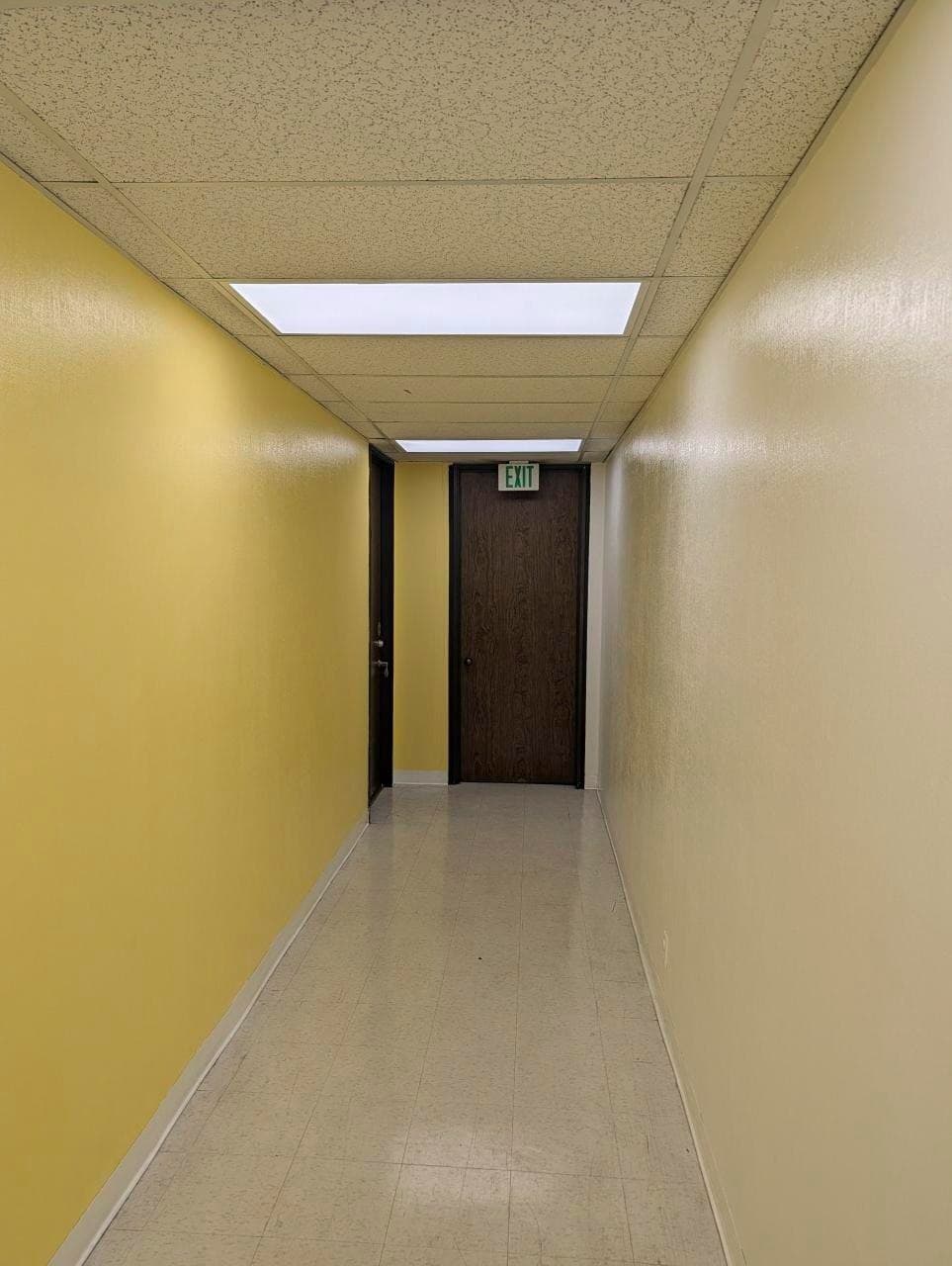 Yellow-wall corridor on the second floor leading to Suite 205
