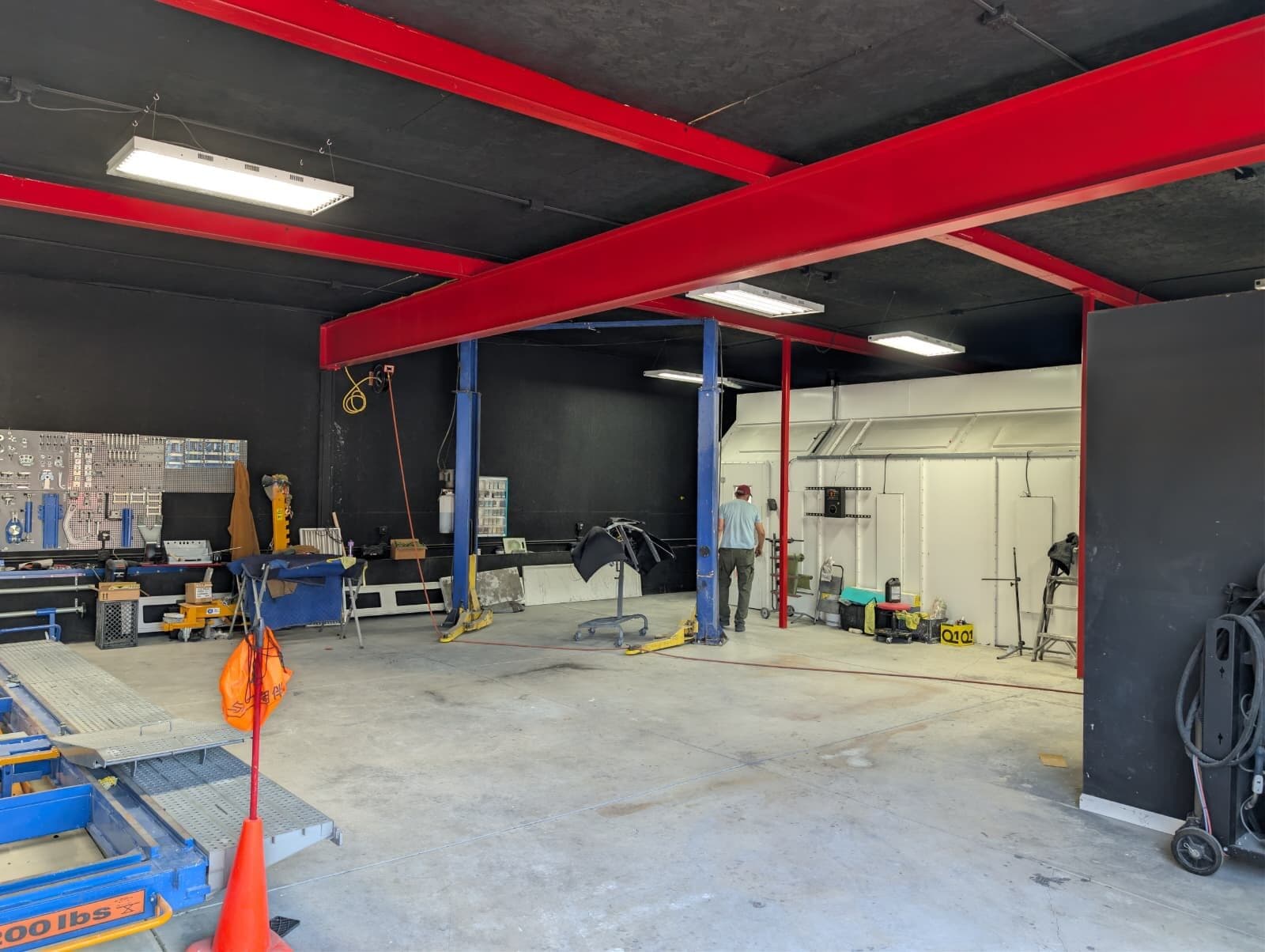 Auto-service work bay with overhead lifts and shop equipment