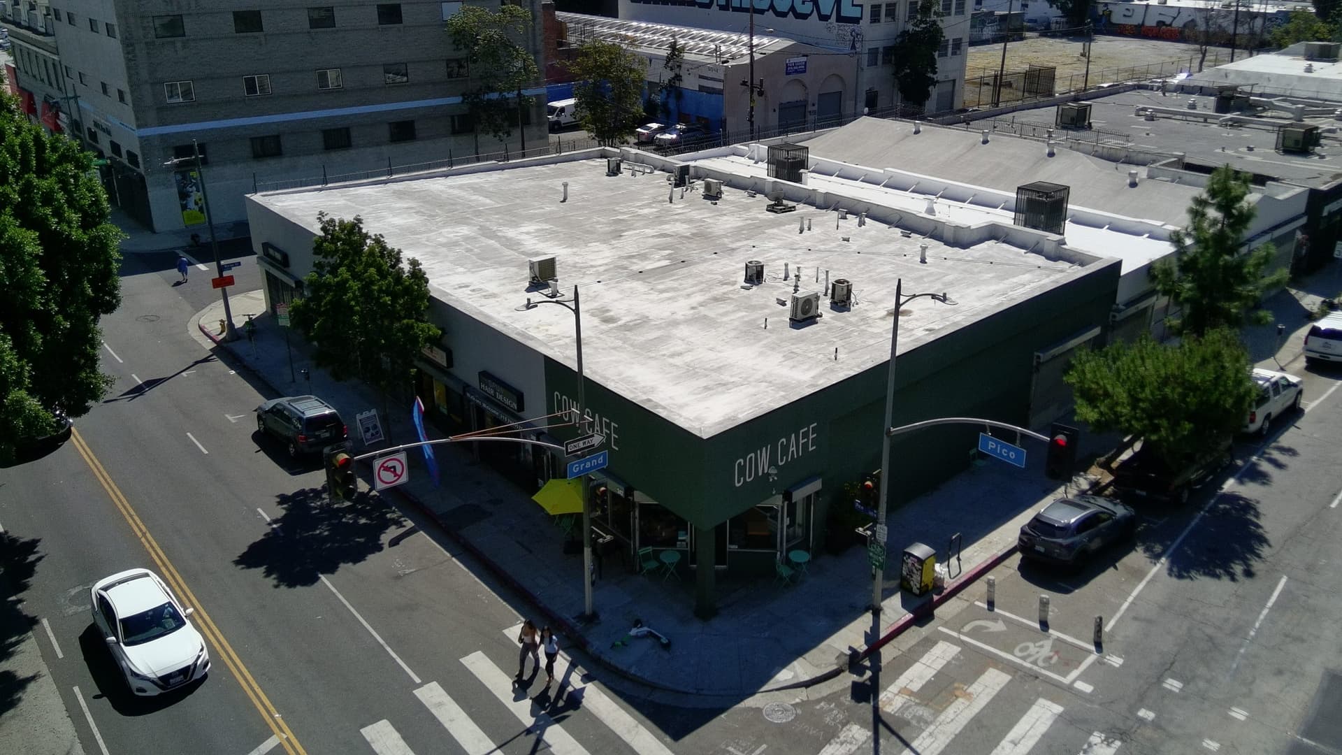 Corner of West Pico Boulevard and South Grand Avenue, showing the full building and both street signs